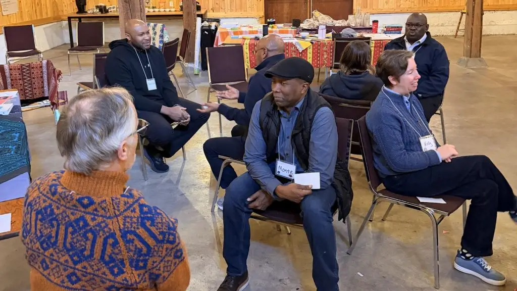 Participants seated in a circle in conversation during an Engage Difference! DUIM program